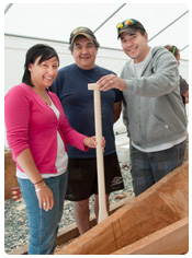 Carvers beside the canoe
