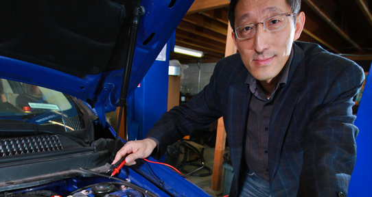 Researcher working on a car