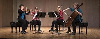 Four musicians performing