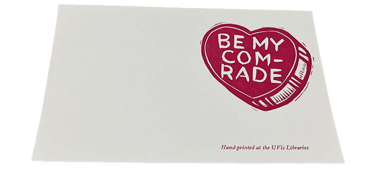 Pink heart stamp on an off-white card with text reading "Be my comrade."