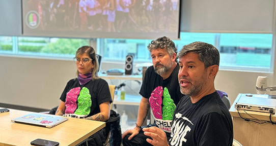 A photo of Vanessa Morris (left) and Julian Quintero of Acción Técnica Social and Jaime Arredondo (right) of the Canadian Institute for Substance Use Research addressing a classroom.