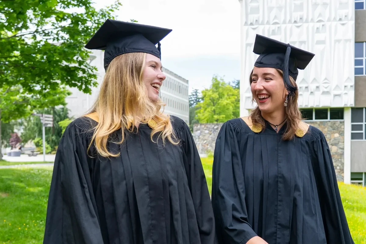 Camryn and Maya in their grad gowns and capts