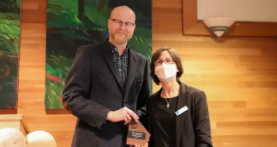 David Leitch receiving his plaque from Laura Cowen