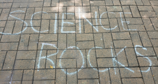 Science rocks written in chalk on the ground