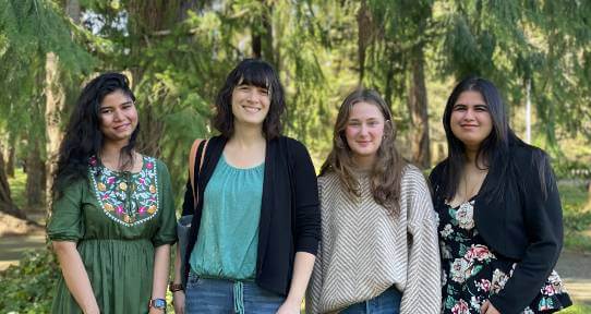 Nicole Templeman with her research group, which consists of three female researchers, taken against a backdrop of trees
