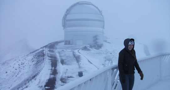 A UVic student in front of the Gemini Observatory during a co-op work term.