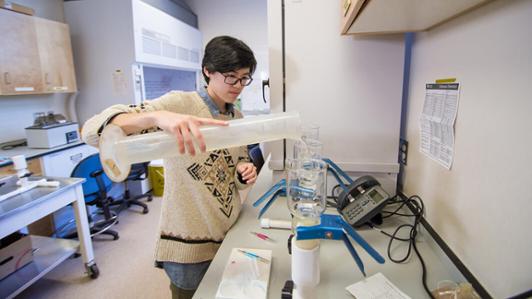 A UVic geography student prepares chemicals for analysis in a lab.