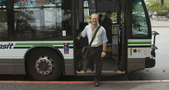 UVic campus community member disembarking from a bus