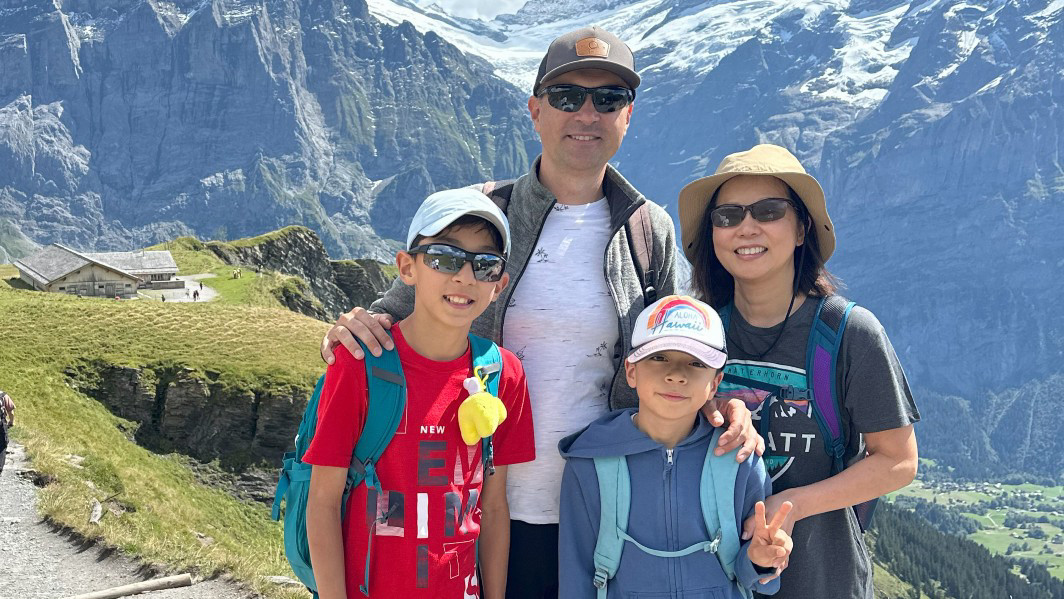 Georgi Ignatov posing in front of a mountain with his wife and two children