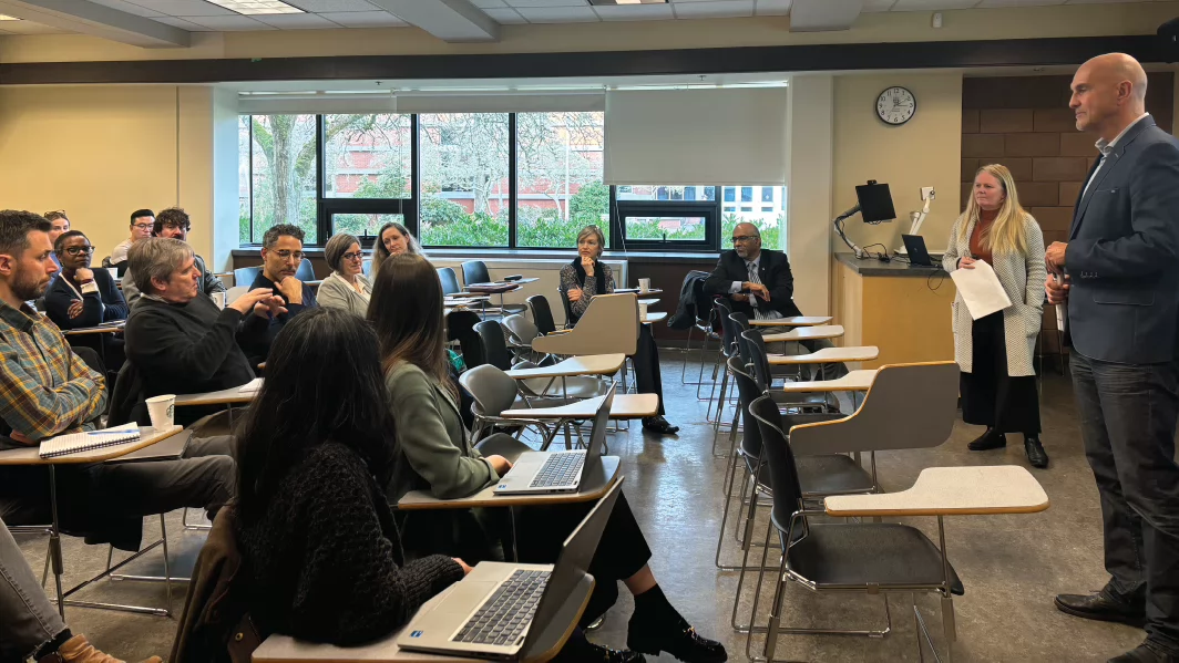 Photo of Oliver Schmidtke and Jodie Walsh from the Center of Global Studies, sharing their work in front of a full classroom as part of the International Community of Practice at UVic, in February 2025