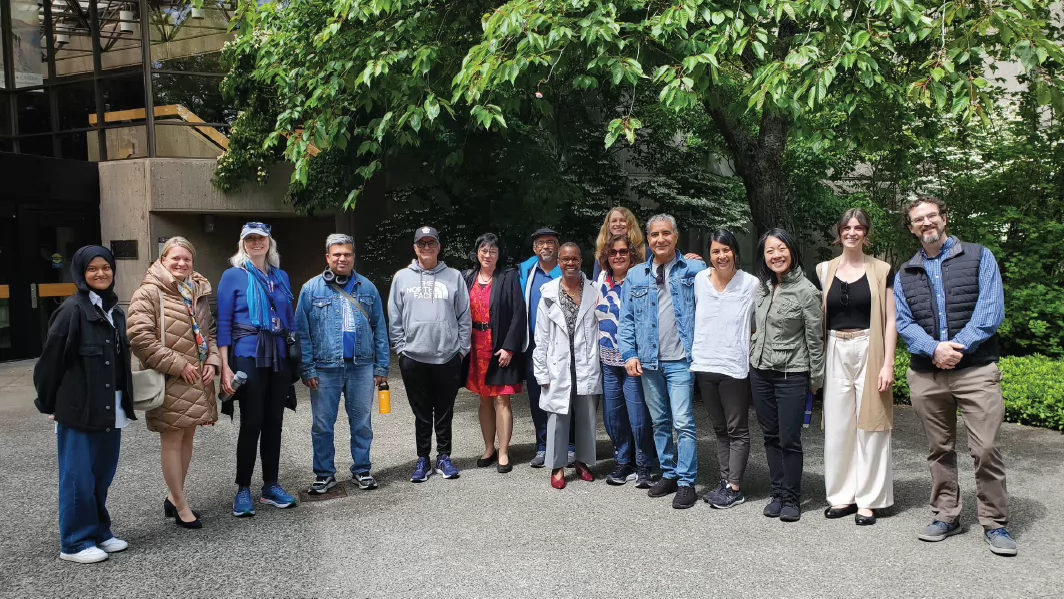 Photo of the fifteen participants of the 2025 UVic World Partnership Walk, outside the Jamie Cassels Building