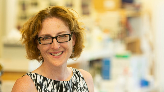 Dr. Caroline Cameron from the shoulders up looks directly at the camera and smiles