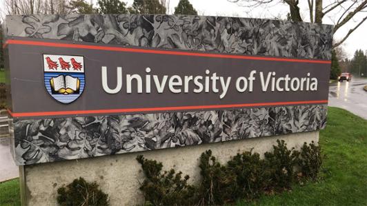 Image of a large sign on a campus entry way with the text and logo: "University of Victoria"