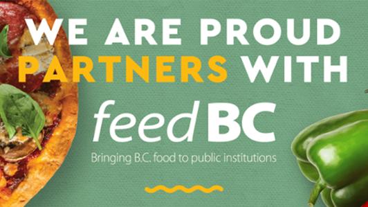 Poster of UVic Food Services with a pizza and some vegetables in the background and the legend: "We are proud partners with feed BC. Bringing B.C. food to public institutions"