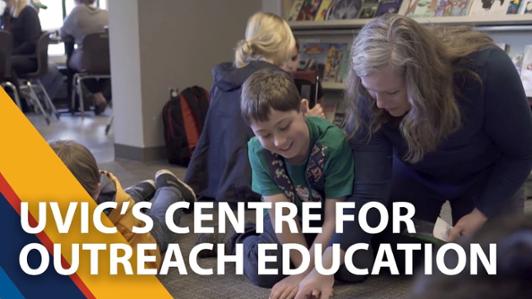 Picture of a group of kids reading and laughing on the floor of a library with an adult tutor, ant the text: "UVic's Centre for Outreach Education"  