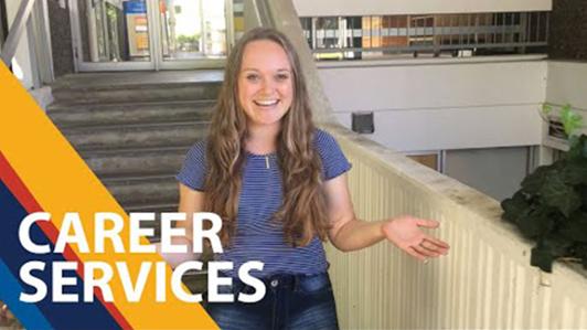 Photo of a young female student at a UVic building smiling at the camera, with the label: "Career Services"