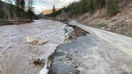 Photo of a highway washed by a grown river in the British Columbia Interior during 2021