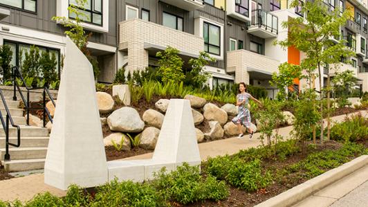 Child skips in front of a row of townhouses
