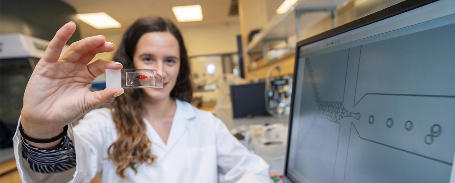 researcher holding sample in lab