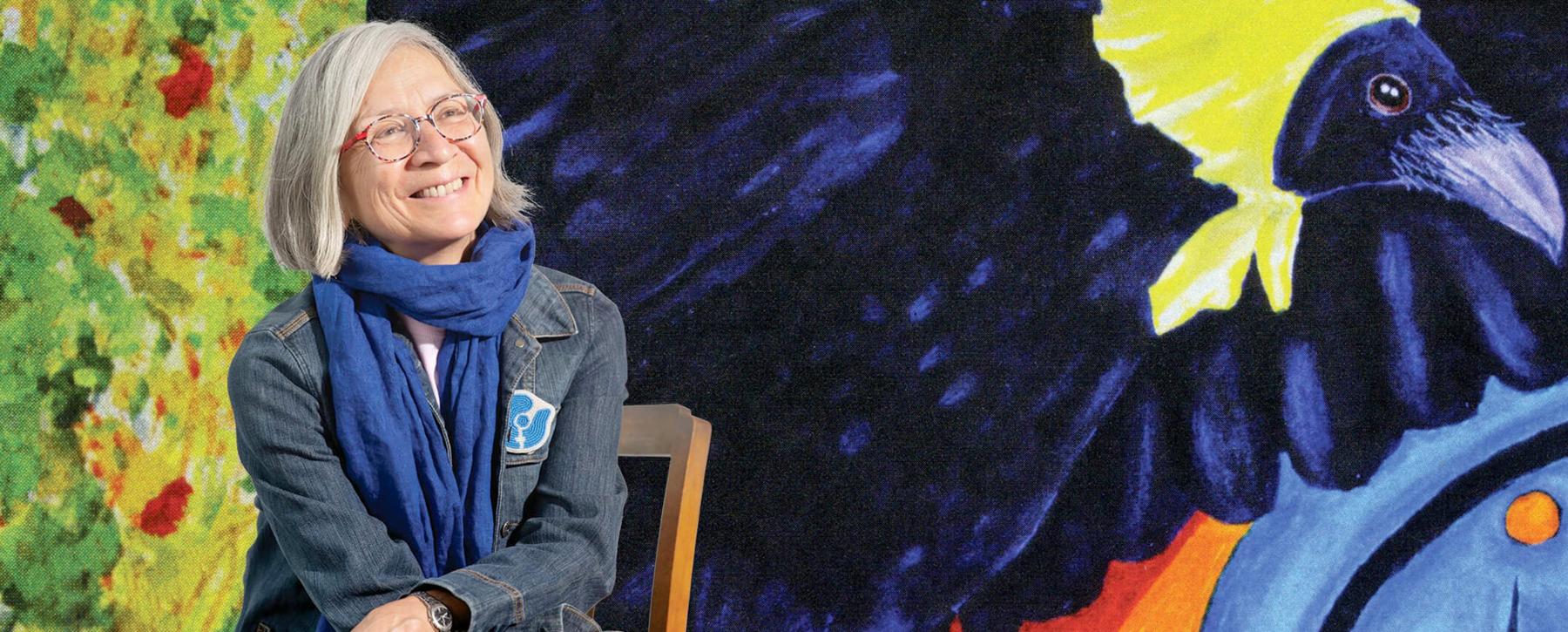 Dr. Val Napoleon in front of her painting