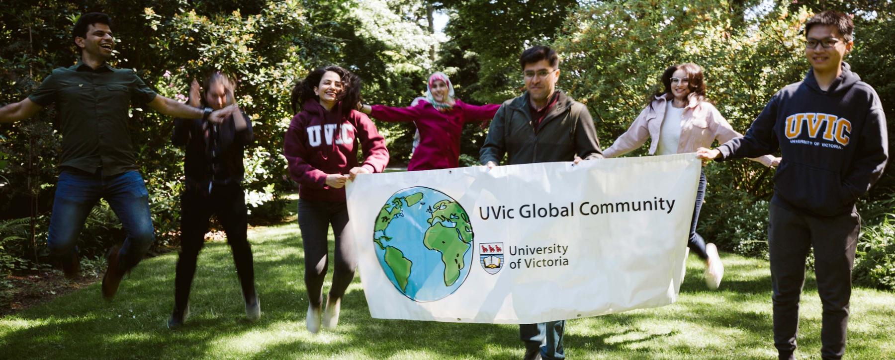 group of students holding banner