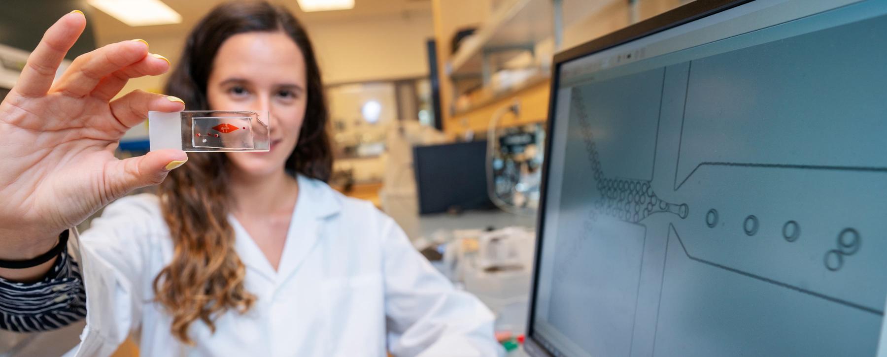 researcher holding sample in lab