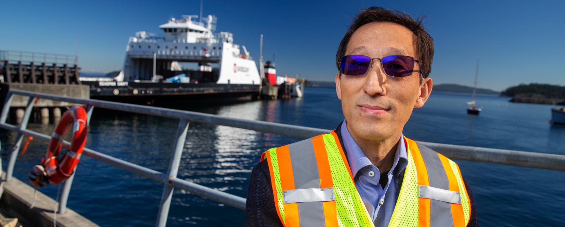 researcher with ferry in background