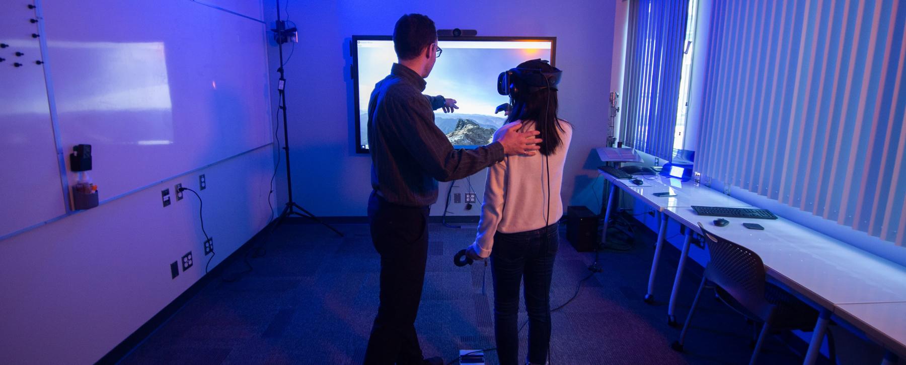 research with student wearing goggles looking at screen