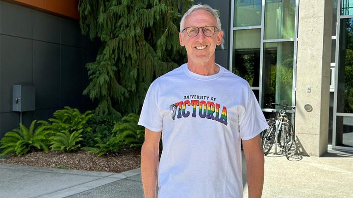 President Kevin Hall with a rainbow UVic logo t-shirt.