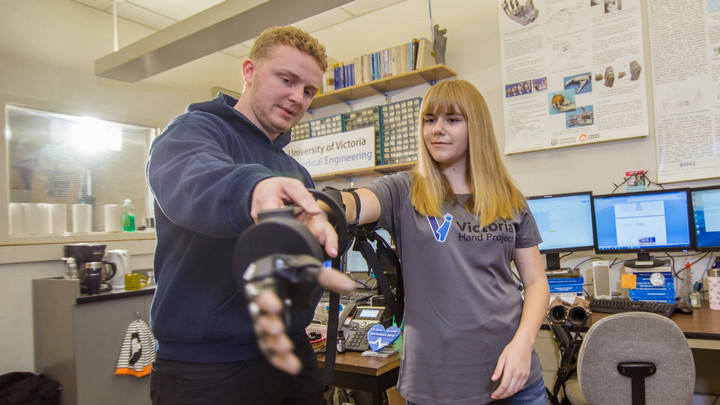 Inventor demonstrating robotic arm