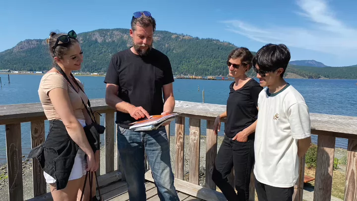 Photo of students working with Dr. Oliver Brandes next to the ocean