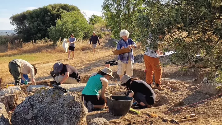 Image of a group of UVic students cleaning and archeological site as part of the Eleon field school in Greece