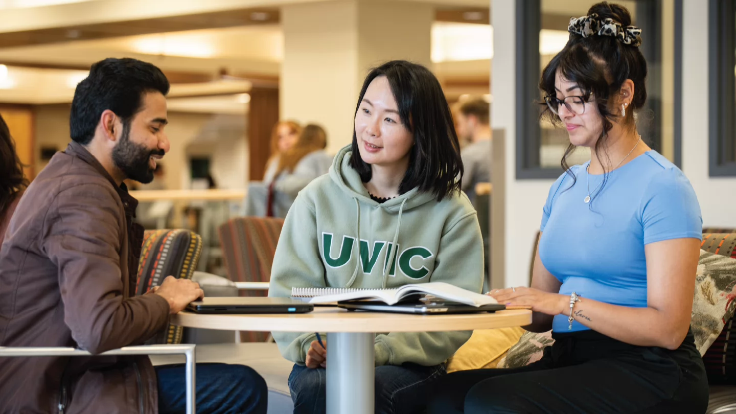 Photo of three UVic students from diverse backgrounds working at the Libraries 