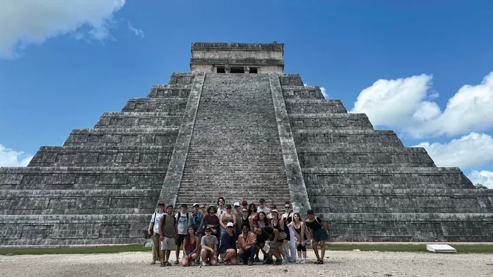 Photo of a group of students in front of the Chichen Itza Pyramyd in Yucatan as part of the Mexico field trip