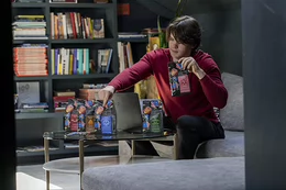 Jack Taylor displays bags of coffee on a table.
