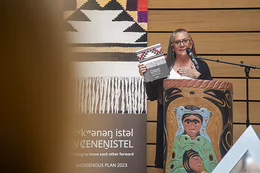 Qwul’sih’yah’maht, Dr. Robina Thomas holds the Indigenous plan document.