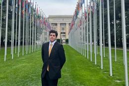 UVic student Stephen Joyce stands on the lawn in front of the United Nations building in Geneva.