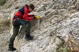 Geologist Stacey Edmonsond examines a rock face.