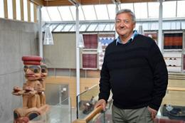 Indigenous health trailblazer Jeffrey Reading stands in a building corridor.