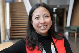 A smiling student in the Centre for Indigenous Law at UVic.