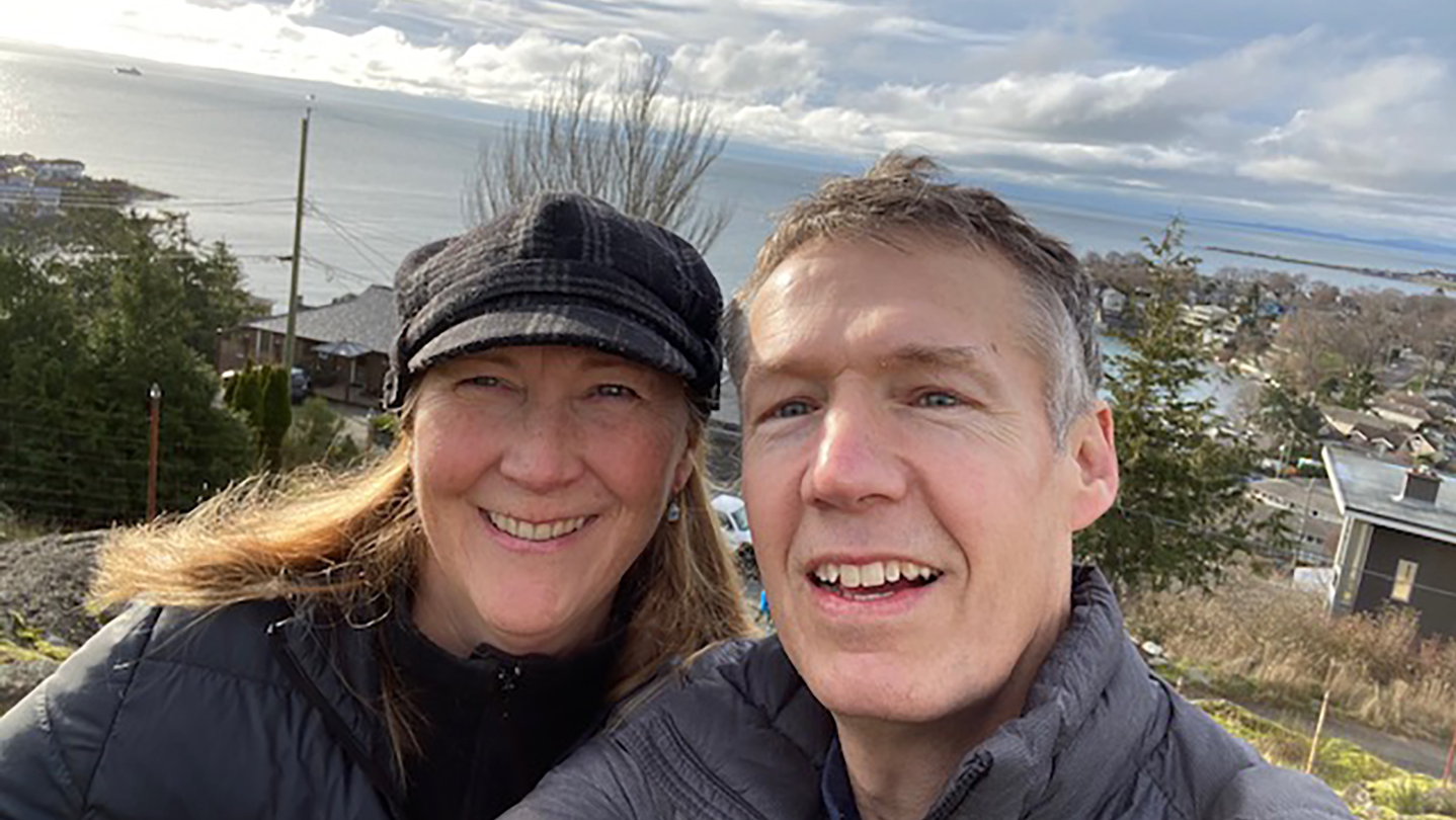 Allyson Hadwin and husband Chris smile in a selfie photo in front of the ocean