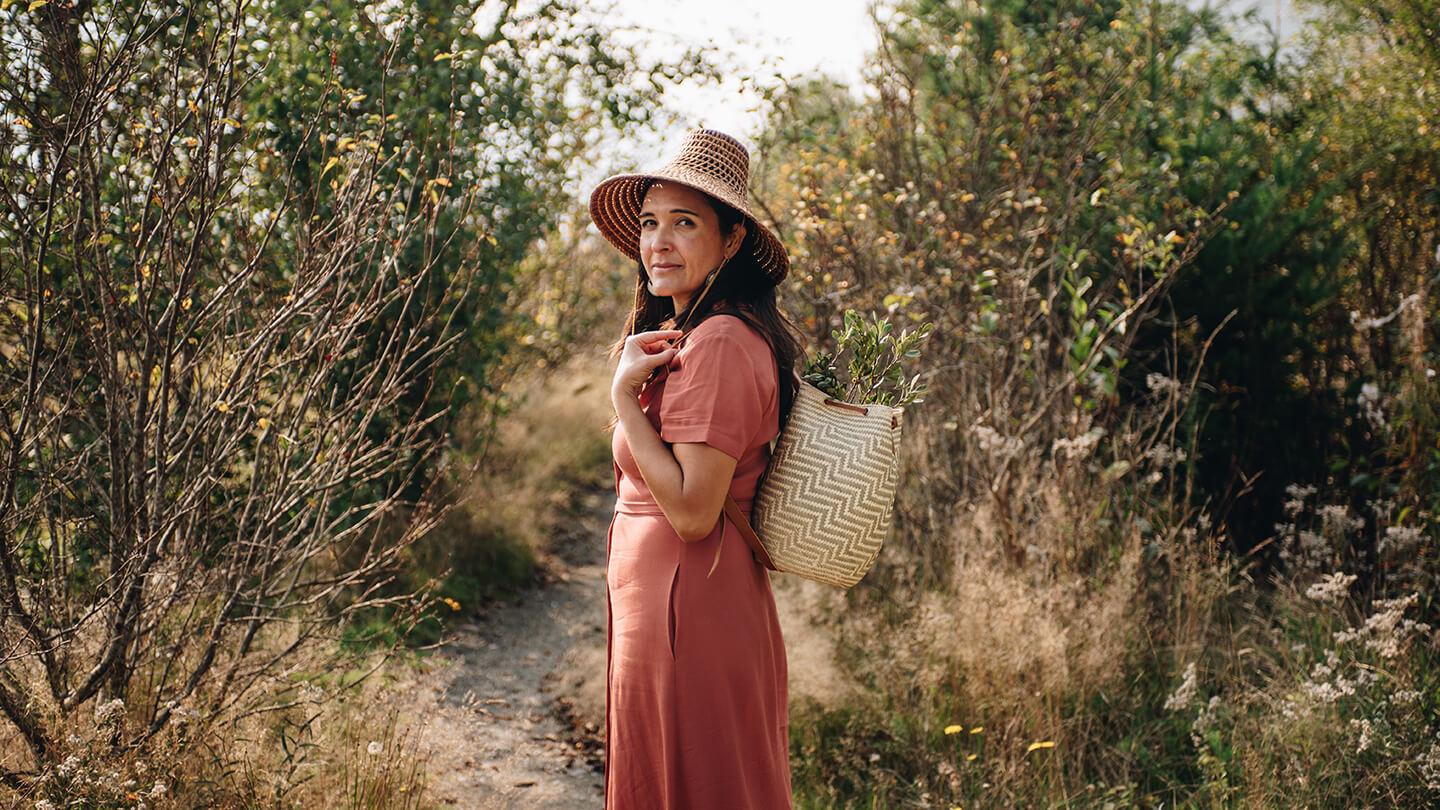 Leigh Joseph outdoors carrying a basket.