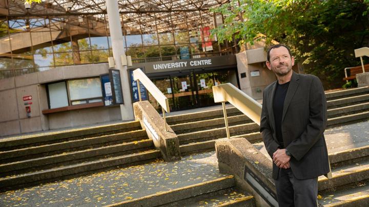 Jamie Cassels stands in front of University Centre