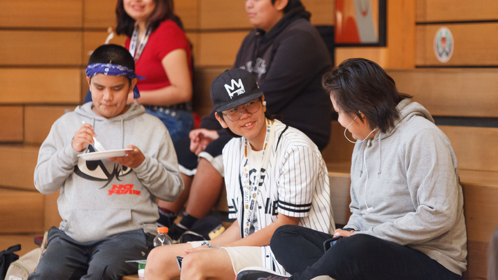 A group of mini-u campers talking to one another sitting in the Ceremonial Hall.