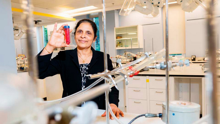 Devika Chithrani in lab holding testube