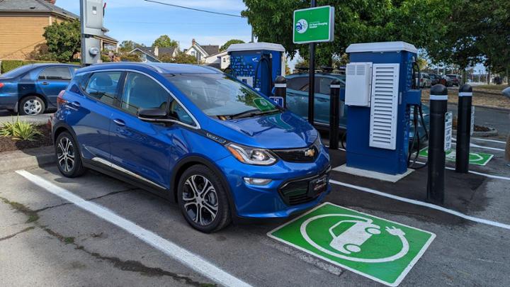 An electric car charging at a new EV charging station