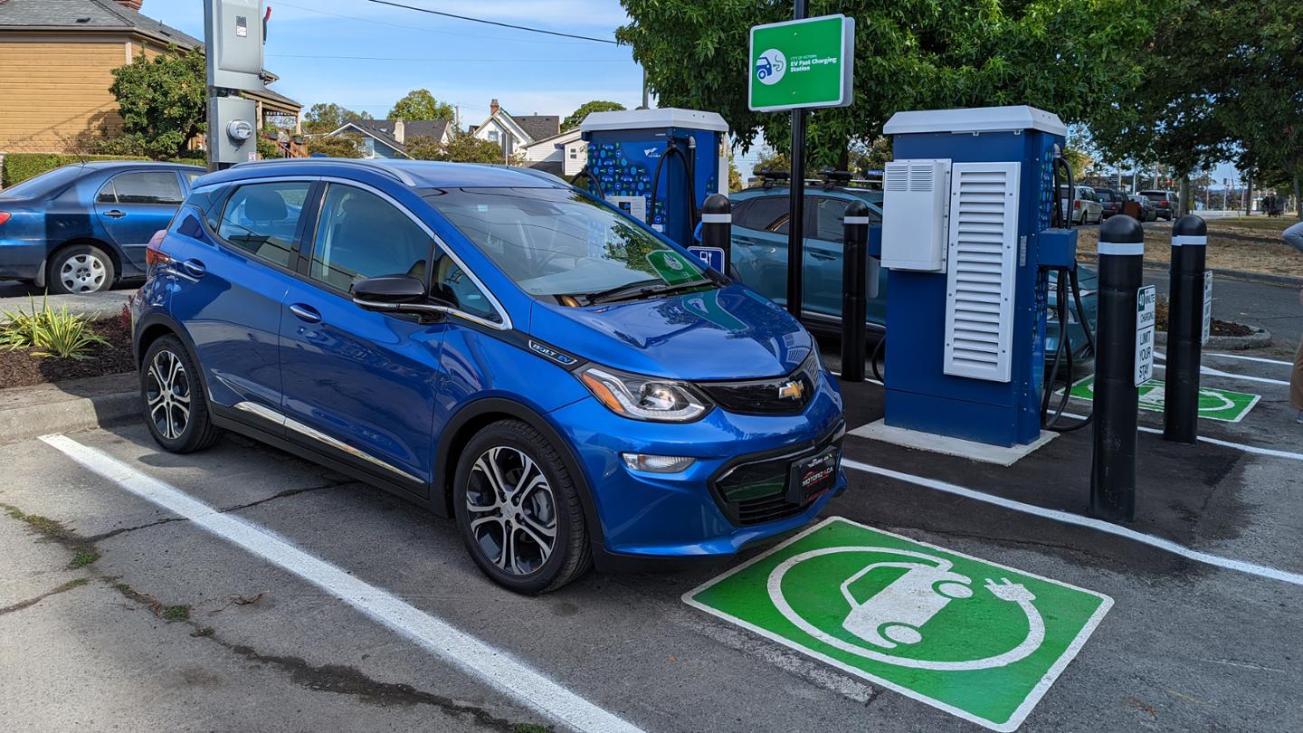 An electric car charging at a new EV charging station