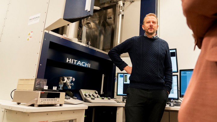 Arthur Blackburn stands with the STEHM in the electron microscopy suite