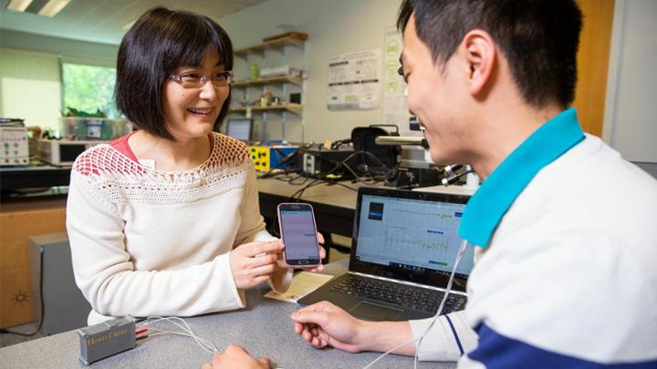 researcher with mobile phone and student