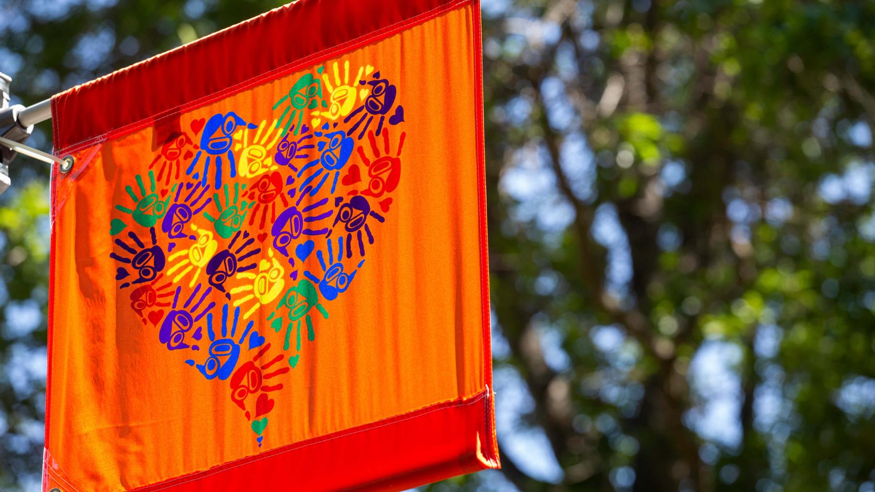 Carey Newman's artwork hangs on a banner at UVic campus.